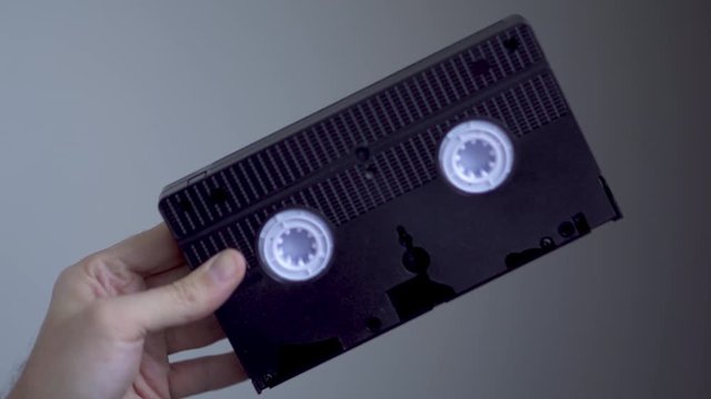 Holding a Blank Black VHS Tape