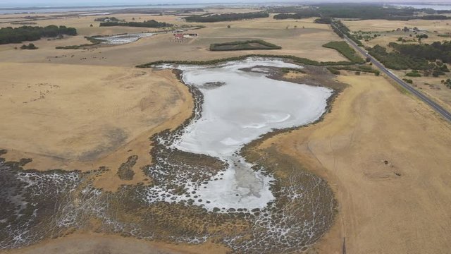 A drought affected agricultural irrigation dam in regional Australia that has turned to a salt pan
