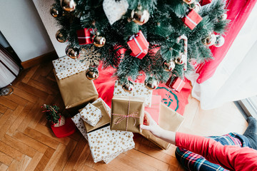 mother at home wrapping christmas presents