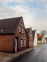 Fototapeta na wymiar Norden, Germany. 8 December 2019. Small red brick working class homes.