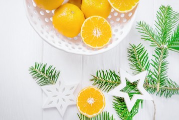 Merry Christmas and Happy New Year. Tangerines or mandarins and Christmas decorations stars on a...
