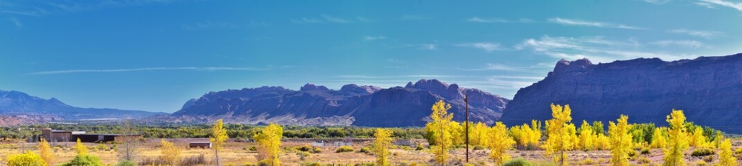Fototapeta premium Looking back towards Moab Panorama views of desert mountain ranges along Highway 191 in Utah in fall. Scenic nature near Canyonlands and Arches National Park. United States of America. USA.