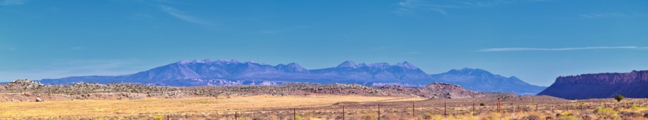 Looking back towards Moab Panorama views of desert mountain ranges along Highway 191 in Utah in fall. Scenic nature near Canyonlands and Arches  National Park. United States of America. USA.