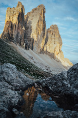 The tre cime di lavaredo (three peaks of lavaredo) reflecting in a pond in the Dolomites, Italy