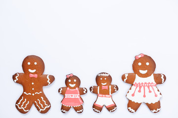 The hand-made eatable gingerbread family on white background