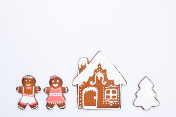 The hand-made eatable gingerbread house, little men on white background