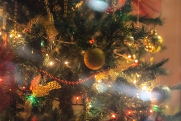 Obraz na płótnie Canvas Christmas tree background - baubles and branch of spruce tree. Defocused