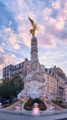 Rose violet sky and Erlon square angel statue in Reims city center, France - 310947583