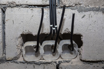 Electrical outlet with wires sticking out. Electricity wiring.