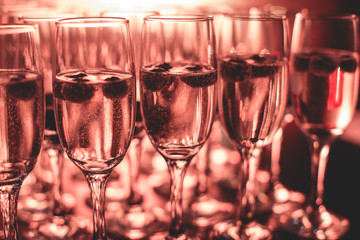 View of alcohol setting on catering banquet table, row line of different colored alcohol cocktails on a party, martini, vodka, and others on decorated catering bouquet table event