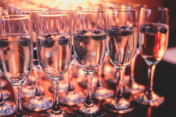 View of alcohol setting on catering banquet table, row line of different colored alcohol cocktails on a party, martini, vodka, and others on decorated catering bouquet table event