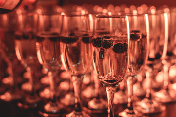 View of alcohol setting on catering banquet table, row line of different colored alcohol cocktails on a party, martini, vodka, and others on decorated catering bouquet table event