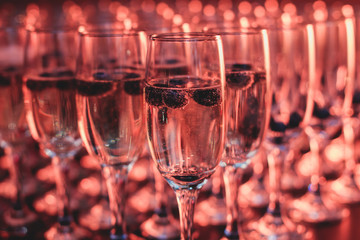 View of alcohol setting on catering banquet table, row line of different colored alcohol cocktails on a party, martini, vodka, and others on decorated catering bouquet table event