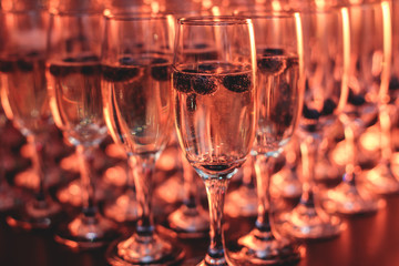 View of alcohol setting on catering banquet table, row line of different colored alcohol cocktails on a party, martini, vodka, and others on decorated catering bouquet table event