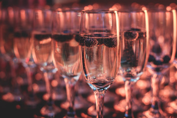 View of alcohol setting on catering banquet table, row line of different colored alcohol cocktails on a party, martini, vodka, and others on decorated catering bouquet table event