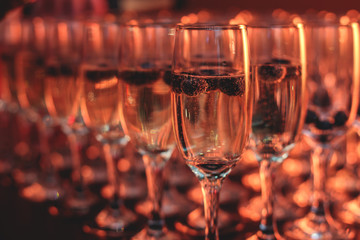 View of alcohol setting on catering banquet table, row line of different colored alcohol cocktails on a party, martini, vodka, and others on decorated catering bouquet table event
