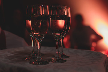View of alcohol setting on catering banquet table, row line of different colored alcohol cocktails on a party, martini, vodka, and others on decorated catering bouquet table event