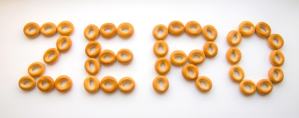 inscription ZERO folded from bagels on a white background top view