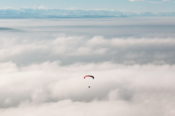 paraglider in the sky against mountains