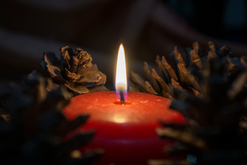 burning candle on black background