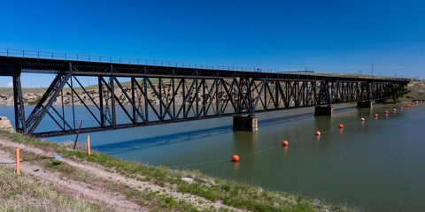 Fototapeta na wymiar MAY 23 2019, GREAT FALLS AREA, MONTANA, USA - Old Railroad bridge across Missouri River near Great Falls, Montana