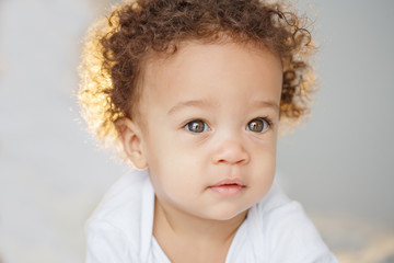 Cute baby with fluffy hair. Pretty boy.