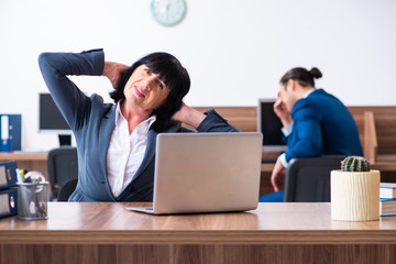 Two employees doing sport exercises in the office