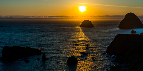 MAY 30, 2019, OREGON COASTLINE, USA - Sunset of sea stacks of rocks Oregon Coast line