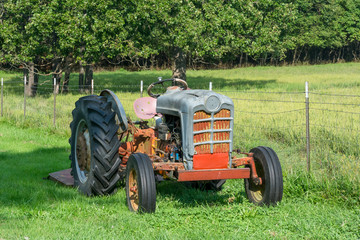Old Tractor by a Fence in a Field