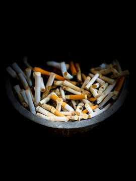 Cigarette butts in an ashtray in dark scene wallpaper backgrounds