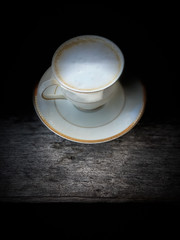 Cup of coffee cappuccino in dark scene on wood table food and drink backgrounds