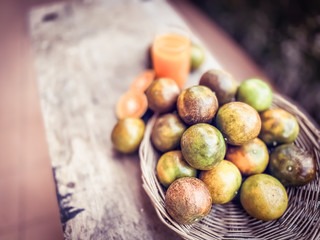 Orange fruits in the basket on wood table scene plant and fruits backgrounds