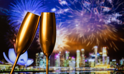 golden champagne glasses and fireworks  new year in Singapore