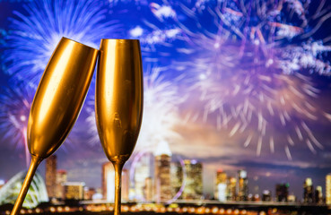 golden champagne glasses and fireworks  new year in Singapore