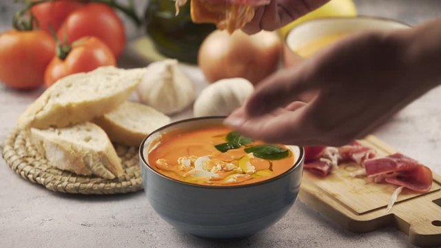 Eating salmorejo with bread and serrano ham