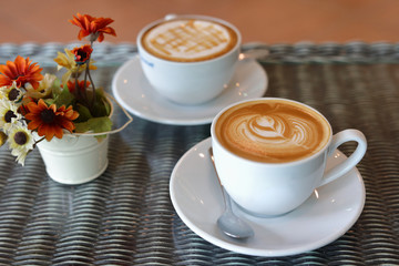 hot caramel macchiato and latte coffee drink put on table in cafe