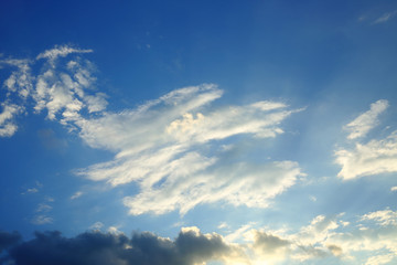 Naklejka na ściany i meble sunlight shine through cloud on dramatic blue sky background