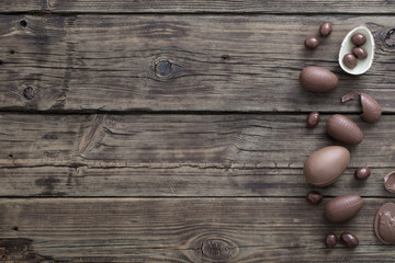 Fototapeta na wymiar chocolate eggs on dark wooden background