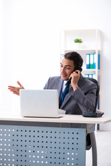 Fototapeta premium Young male accountant working in the office