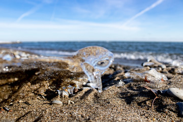 Ice shapes on the beach from rocks and pebbles in the winter