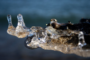 Ice shapes on the beach from rocks and pebbles in the winter