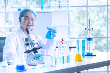 Fototapeta premium Asian woman scientist, researcher, technician, or student conducted research in laboratory