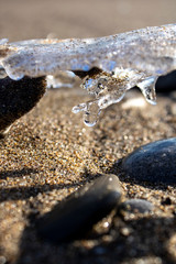 Frozen shapes of rock and sand in the beach in the winter