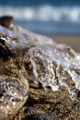 Frozen shapes of rock and sand in the beach in the winter