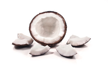Half coconut and coconut pieces isolated on white background