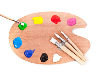 Palette with paints and brushes isolated on a white background.