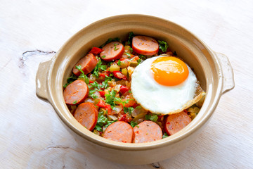 Spanish dish pisto manchego with chorizo sausages and fried egg