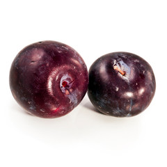 Red plums isolated on a white background.
