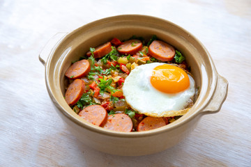 Spanish dish pisto manchego with chorizo sausages and fried egg