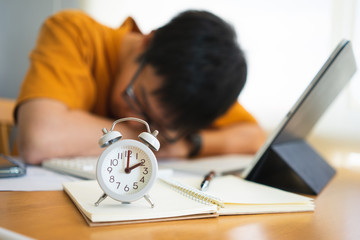 Businessman tired from working with digital tablet and overtime workload at the home office....